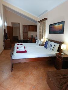 a bedroom with a large bed and a couch at Villa Beatrix Budva in Budva