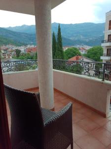 a balcony with two chairs and a view of a city at Villa Beatrix Budva in Budva