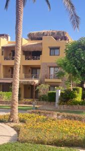 un edificio con una palmera delante de él en Luxury Chalet in Mountain View 2 , El-Sokhna with Sea View , Pool View and Garden View Families Only, en Ain Sokhna