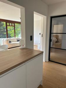 a kitchen with a counter top and a living room at Le Chalet du Pays de Herve in Herve +16 photos