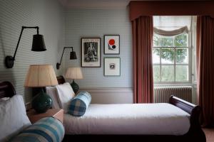 a bedroom with two beds and a window at Cavendish Hotel in Baslow