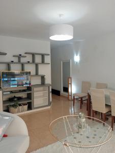 - un salon avec une table et une télévision dans l'établissement Playa Beach Malaga 3habts dobles, cocina familiar, apartamento completo, à Cala del Moral