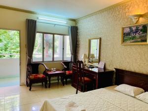 a bedroom with a desk and a room with a bed and a desk at Lam Son Hotel in Vung Tau