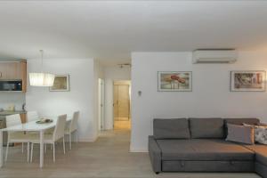 a living room with a couch and a table at Apartment Alva Lloretholiday in Lloret de Mar