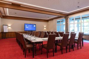 a conference room with a long table and chairs at Sporthotel Igls in Innsbruck