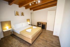 a bedroom with a bed with two towels on it at Quattro Canti in Carini