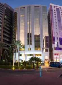 a large building with a blue fire hydrant in front of it at Al Rawda Arjaan by Rotana, Abu Dhabi in Abu Dhabi