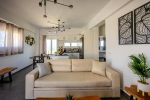 a living room with a couch and a kitchen at FN Suites in Monolithos