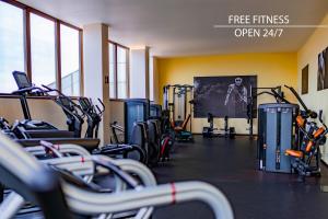 a gym with several treadmills and cardio machines at Grand Hotel Prague Towers in Prague