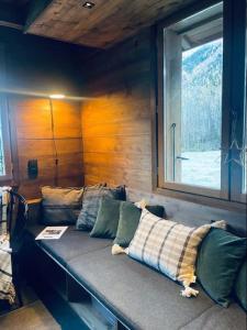 a couch sitting in a room with a window at Le Chalet Georges in Chamonix