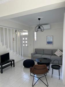 a living room with a couch and a table at Mary Lo Guest House in Nydri