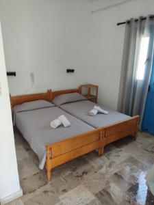 a bedroom with a bed with two towels on it at Manolis Rooms Vathys in Kalymnos