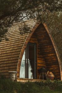 a house with a large arched window with a door at Tempo Manor Cabins in Tempo