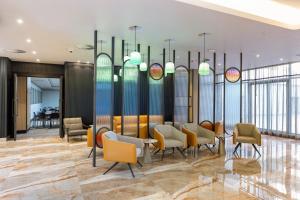 a lobby with chairs and a waiting area at Coastlands Skye Hotel, Ridgeside, Umhlanga in Durban