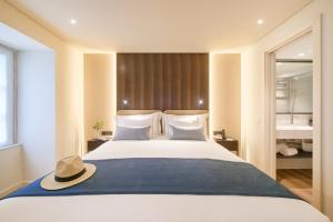 a bedroom with a large bed with a hat on it at Hotel Moon & Sun Lisboa in Lisbon +44 photos