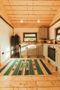 a kitchen with a rug in the middle of it at Tempo Manor Cabins in Tempo