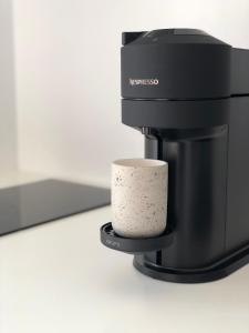 a coffee maker with a cup on a stand at AESIS in Krokos