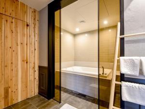 a bathroom with a bath tub and a shower at Brown Dot Yangjeong in Busan +51 photos