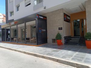 a store front of a building with tables and chairs at Town Hotel in Kenitra