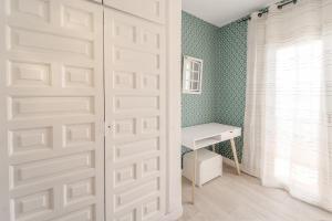 a white door in a room with a desk at WELCS CASA ADOSADA 144 EMP con piscina comunitaria in Montjoys +10 photos
