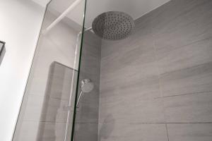 a shower with a glass door in a bathroom at Lavish 4BR Apartment in the Heart of CPH by The Canals in Copenhagen +63 photos
