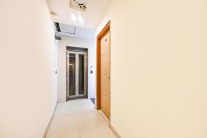 a hallway with a door and a mirror at FabEscape Panchkula Motels in Panchkula