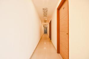 a hallway with white walls and a long corridor at FabEscape Panchkula Motels in Panchkula