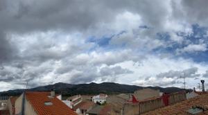 a view of a city with buildings and a cloudy sky at Casa Rural Angeles in Catí