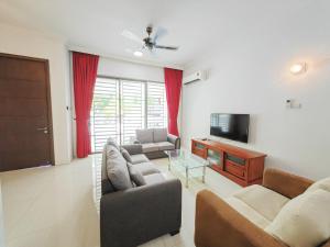 a living room with two couches and a television at 162 Home4Stay Deluxe Big 3story 6Rooms 20pax Wedding USM Arena Bridge in Gelugor
