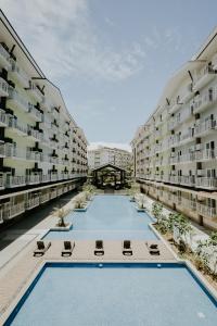 an empty apartment building with a swimming pool at Amani Grand #332, Near Mactan Airport,Fast WIFI, Netflix & Pool in Pusok