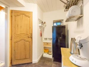 a kitchen with a wooden door and a refrigerator at Apartment with a shared sauna in Bichlbach in Bichlbach