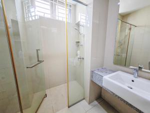a white bathroom with a shower and a sink at 162 Home4Stay Deluxe Big 3story 6Rooms 20pax Wedding USM Arena Bridge in Gelugor +26 photos
