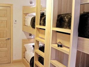 a room with four bunk beds in a room at Destination Franc Sud Gaspésie in Cascapedia