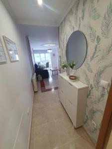 a hallway with a mirror and a dresser in a room at Mirasol in Viveiro +15 photos