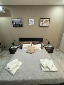 a bedroom with a large bed with towels on it at Little Dreams in Caserta