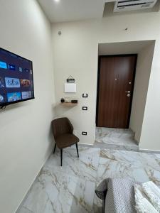 a room with a chair and a door at Little Dreams in Caserta