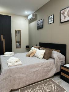a bedroom with a large bed with towels on it at Little B&B in Caserta +11 photos