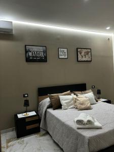 a bedroom with a bed with two tables and two pictures on the wall at Little Dreams in Caserta +9 photos