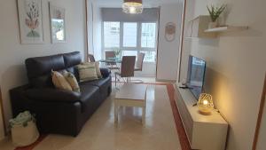 a living room with a couch and a table at Mirasol in Viveiro