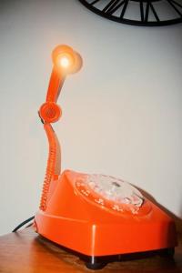 an orange phone sitting on top of a table at Au Béguinage - Studio au coeur de wavre in Wavre