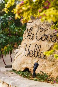 a rock with a sign that says go to college at Finca Sa Cova Vella in Manacor