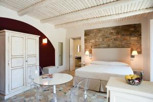 a hotel room with a bed and a table and chairs at Rupe Alta Home in Castellabate +20 photos