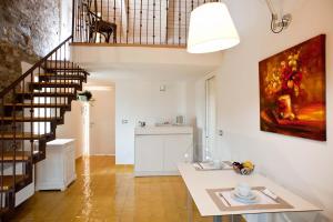 a living room with a staircase and a painting on the wall at Rupe Alta Home in Castellabate
