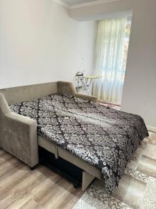 a bedroom with a large bed in a room at 2 комнатная квартира студио на Иссык куле in Chok-Tal