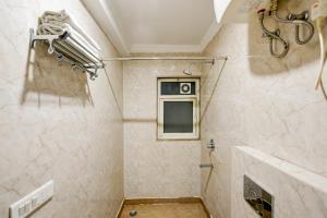 a bathroom with a shower and a window at Airport Hotel Ark View in New Delhi