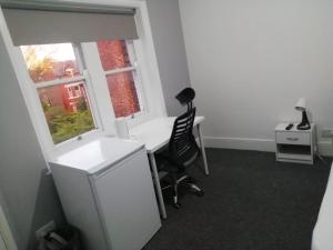 an office with a desk and a chair and a window at Single Room Shared bathroom Free Street Parking Near Anfield LFC in Liverpool