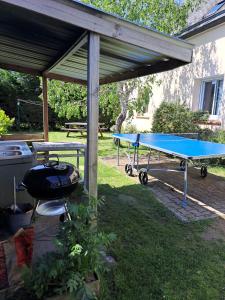 a ping pong table and a picnic table with a ping pong table at Villa bord de mer avec piscine et jacuzzi in Pénestin