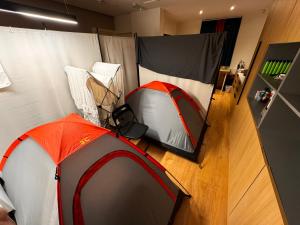 an orange and gray tent in a room at Not Very Quiet but best location in London