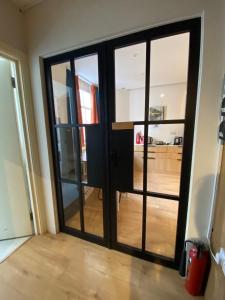 a large glass door in a room with a living room at Not Very Quiet but best location in London