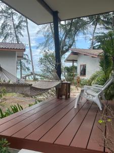 a deck with hammocks and a house at Rim Lay in Ko Kood